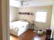 Bedroom with a full-size bed, hardwood floors, and a floating shelf with books at 1723 Oak St, Charlotte, NC 28269