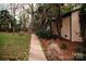 Charming home exterior featuring a landscaped walkway and lush greenery at 1723 Oak St, Charlotte, NC 28269