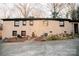 Exterior of brick home with a concrete driveway, mature trees, and manicured landscaping, providing a welcoming curb appeal at 1723 Oak St, Charlotte, NC 28269