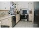 Bright kitchen featuring modern stainless steel appliances and white cabinets at 1723 Oak St, Charlotte, NC 28269