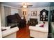 Cozy living room with a fireplace, grand piano, and hardwood floors at 1723 Oak St, Charlotte, NC 28269