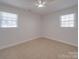 Bright bedroom with neutral carpeting and two windows at 1740 Aaron Ave, Rock Hill, SC 29730