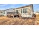 View of backyard deck and home's exterior with large windows for natural light at 17563 Hawks View Dr, Fort Mill, SC 29707