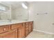 Bathroom featuring a double sink vanity, tiled flooring, and large mirror at 17563 Hawks View Dr, Fort Mill, SC 29707