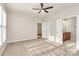 Bright bedroom with a ceiling fan, carpeted floors and a door to the bathroom at 17563 Hawks View Dr, Fort Mill, SC 29707