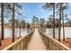 Scenic view of a wooden dock extending over a tranquil lake surrounded by trees at 17563 Hawks View Dr, Fort Mill, SC 29707