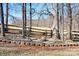 Backyard featuring a fire pit area with bench seating surrounded by trees and wood fence at 1790 Kathy St, Newton, NC 28658