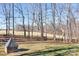 Large grassy backyard with trees, wood fence, and storage shed at 1790 Kathy St, Newton, NC 28658