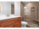 Modern bathroom with a tile shower, glass door, rain shower head, and wooden vanity at 1790 Kathy St, Newton, NC 28658