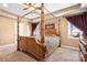 An elegant bedroom boasts a tray ceiling and a beautiful wooden canopy bed at 1790 Kathy St, Newton, NC 28658