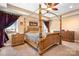 Spacious bedroom featuring a beautiful canopy bed, with side tables and a ceiling fan at 1790 Kathy St, Newton, NC 28658