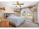 Bedroom featuring a comfortable bed, two large windows, and a dresser, filled with natural light at 1790 Kathy St, Newton, NC 28658