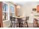 Bright dining area with large windows and a unique wine barrel table with seating at 1790 Kathy St, Newton, NC 28658