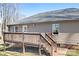 Back exterior view of home with a cozy deck and entrance stairs at 1790 Kathy St, Newton, NC 28658