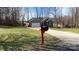 View of the single Gathering home from the driveway, showcasing the brick and siding facade, garage, and front yard at 1790 Kathy St, Newton, NC 28658