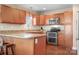 Modern kitchen featuring stainless steel appliances, granite countertops, and wooden cabinets at 1790 Kathy St, Newton, NC 28658