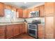 Kitchen featuring wooden cabinets, granite countertops, and stainless steel double oven and microwave at 1790 Kathy St, Newton, NC 28658