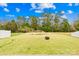 Large backyard with a fire pit, green grass, and trees providing privacy at 191 Sutters Mill Dr, Troutman, NC 28166