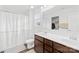 Bright bathroom featuring a double vanity, modern fixtures, and a shower with a white curtain at 191 Sutters Mill Dr, Troutman, NC 28166