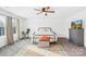 Bright bedroom with a black metal frame bed, a patterned rug, and large windows at 191 Sutters Mill Dr, Troutman, NC 28166