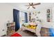 Cozy bedroom with a ceiling fan, carpet flooring, and window with blind coverings at 191 Sutters Mill Dr, Troutman, NC 28166