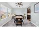 Well-lit dining room featuring a wooden table, upholstered chairs, and decorative wall art at 191 Sutters Mill Dr, Troutman, NC 28166