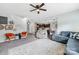 Cozy living room features carpet, a large area rug, and seamless flow to the kitchen at 191 Sutters Mill Dr, Troutman, NC 28166