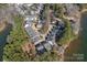 Overhead shot of the beautiful lakefront real estate surrounded by dense trees, highlighting a secluded and peaceful community at 220 Ambleside Village Ln, Davidson, NC 28036