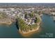 Aerial view of lakefront community with numerous houses at 220 Ambleside Village Ln, Davidson, NC 28036