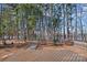 Landscaped backyard with stone path leading to lake at 220 Ambleside Village Ln, Davidson, NC 28036