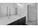 Bathroom with double vanity, quartz countertop and dark cabinetry at 220 Ambleside Village Ln, Davidson, NC 28036