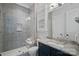 Bathroom with gray tile shower, dark vanity, and granite countertop at 220 Ambleside Village Ln, Davidson, NC 28036