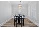 Dining room with a dark wood table, seating for eight, and natural light from shuttered windows at 220 Ambleside Village Ln, Davidson, NC 28036