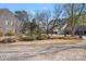 Landscaped front yard with brick driveway and stone houses at 220 Ambleside Village Ln, Davidson, NC 28036