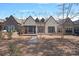 House exterior with stone and stucco siding, deck at 220 Ambleside Village Ln, Davidson, NC 28036