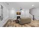 Living room with hardwood floors, fireplace, and stairs leading upstairs at 220 Ambleside Village Ln, Davidson, NC 28036