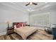 Large bedroom with hardwood floors, ceiling fan, and plantation shutters at 220 Ambleside Village Ln, Davidson, NC 28036