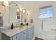 Stylish bathroom with double vanity, marble countertop, and blue cabinets at 2240 Mecklenburg Ave, Charlotte, NC 28205