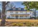 Two-story white house with a front porch and mature trees at 2240 Mecklenburg Ave, Charlotte, NC 28205