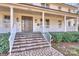 Inviting front porch with stone steps, leading to a charming two-story home at 2240 Mecklenburg Ave, Charlotte, NC 28205