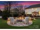 Cozy fire pit area with comfortable seating and stonework at 2240 Mecklenburg Ave, Charlotte, NC 28205