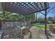 Outdoor kitchen with pergola, grill, and dining area at 2240 Mecklenburg Ave, Charlotte, NC 28205