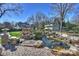 Landscaped backyard with pond and waterfall feature at 2240 Mecklenburg Ave, Charlotte, NC 28205