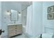 Bright bathroom with a white oak vanity, marble countertop, hexagon floor tiles and framed botanical art at 2270 New Gray Rock Rd, Fort Mill, SC 29708