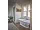 Serene bathroom featuring a soaking tub, a separate glass shower, and natural light at 2270 New Gray Rock Rd, Fort Mill, SC 29708