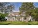 Beautiful home exterior featuring a stone chimney, manicured lawn, and lush greenery, creating a picturesque setting at 2270 New Gray Rock Rd, Fort Mill, SC 29708