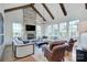 A bright living room featuring a stone fireplace, exposed beams, and large windows providing natural light at 2270 New Gray Rock Rd, Fort Mill, SC 29708