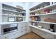 Walk-in pantry provides an abundance of storage space with custom cabinets, shelving, and an integrated microwave at 2270 New Gray Rock Rd, Fort Mill, SC 29708