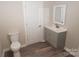 Bathroom with toilet and grey vanity at 291 Patterson Farm Rd, Mooresville, NC 28115