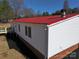 White sided home with a red metal roof and brick foundation at 291 Patterson Farm Rd, Mooresville, NC 28115